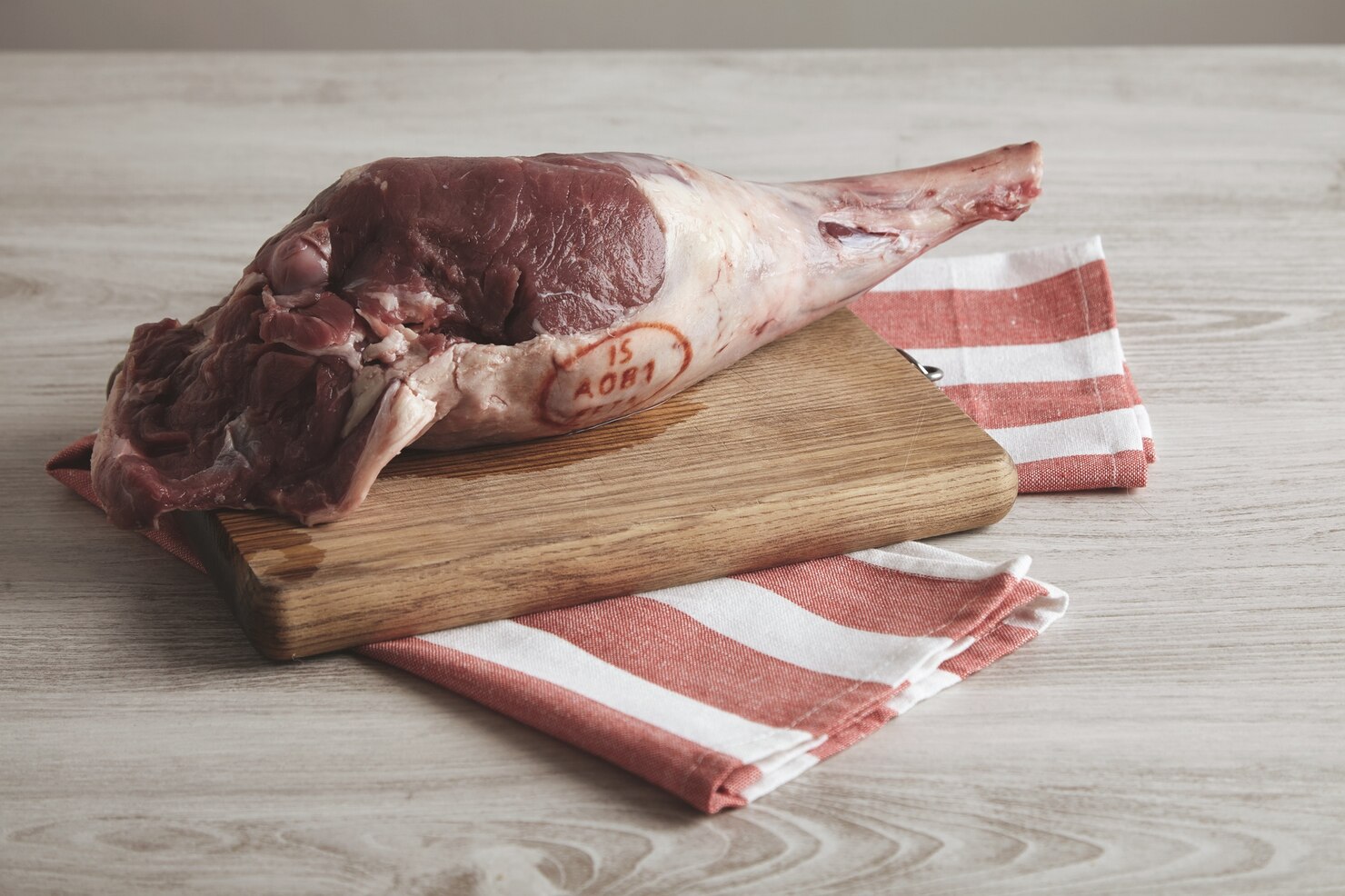 top side view icelandic raw lamb leg isolated striped towel wooden board 346278 497